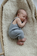 Baby in blue knit overalls - no toy