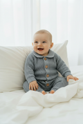 Baby in grey romper - portrait pose