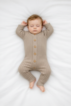 Baby in ribbed onesie - arms up